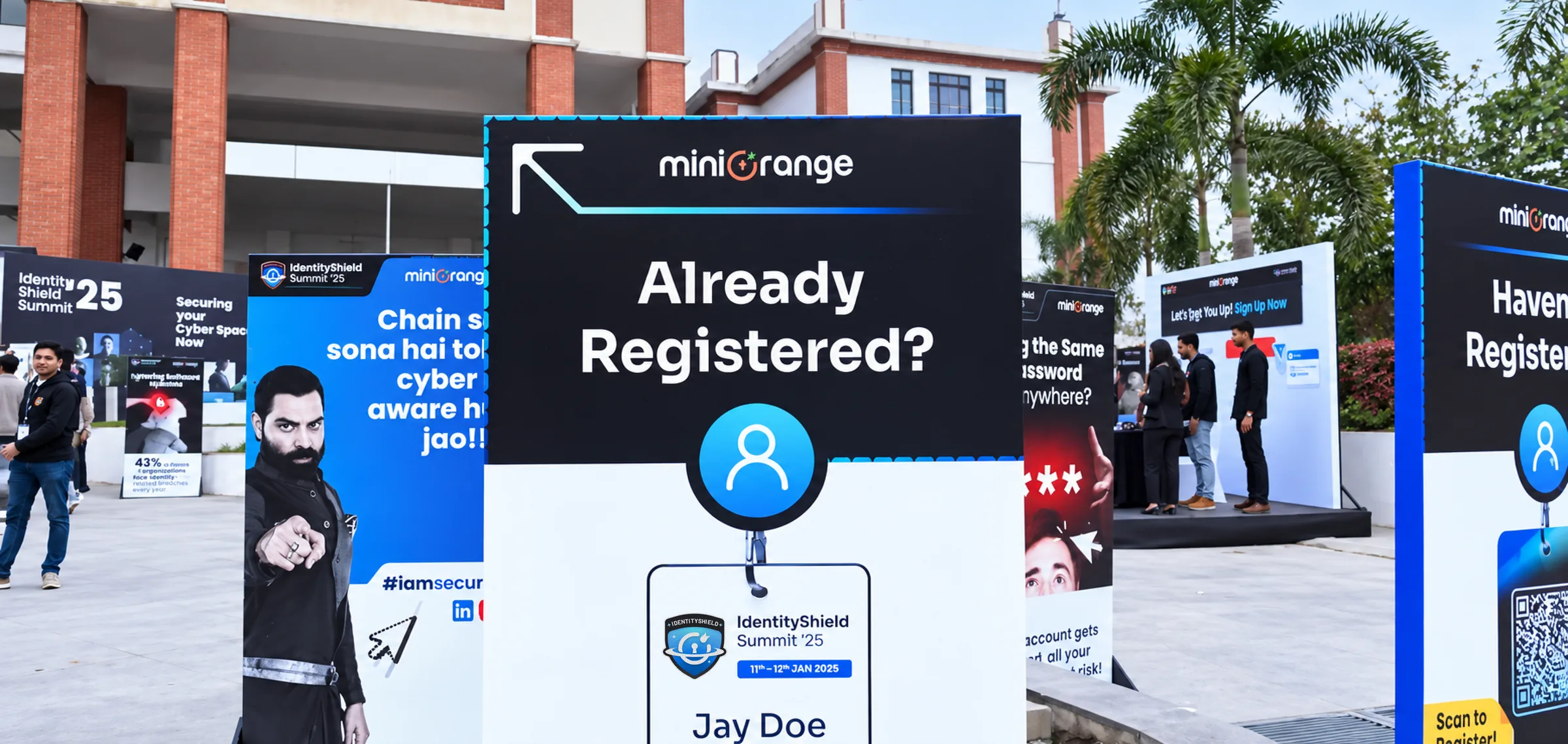 The entrance at IDS ’25: standees reading Already Registered? with an arrow and a badge, and Haven’t Registered? with a QR code, among awareness posters