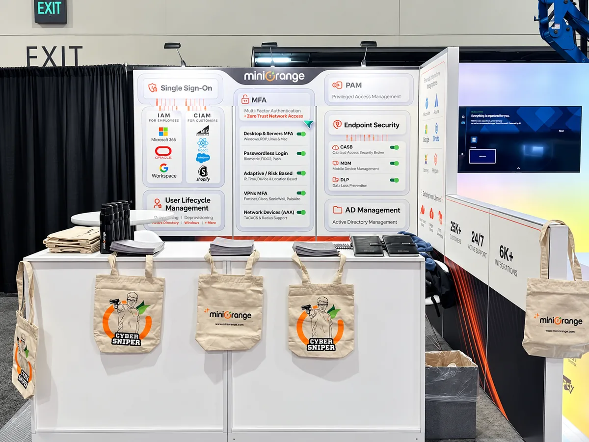 A miniOrange booth with product backdrops and branded tote bags on the counter