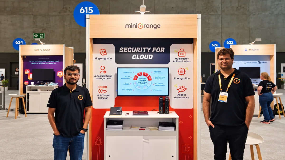 The miniOrange booth at Atlassian Team ’25, with two team members in front of it