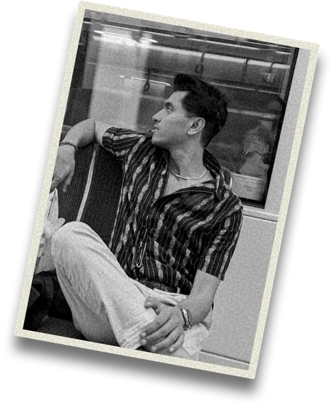 Shraddheya sitting on a train, looking out of the window